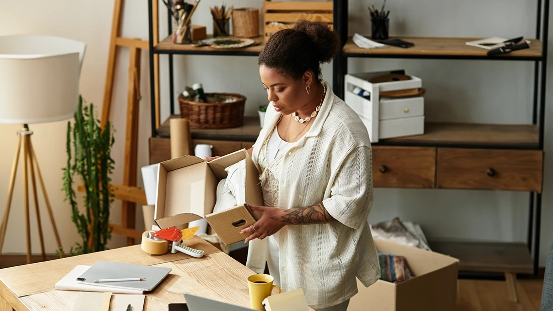 Small business owner packing an order in her studio