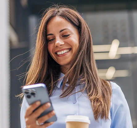 Woman smiling while using phone