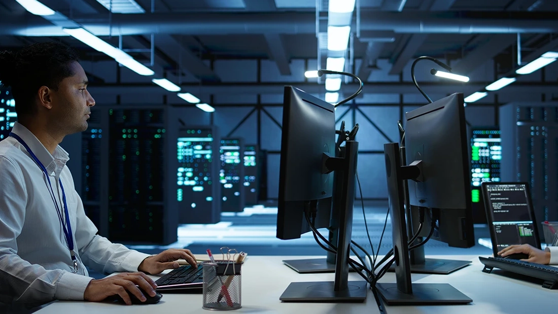 IT technician at a workstation in a data centre
