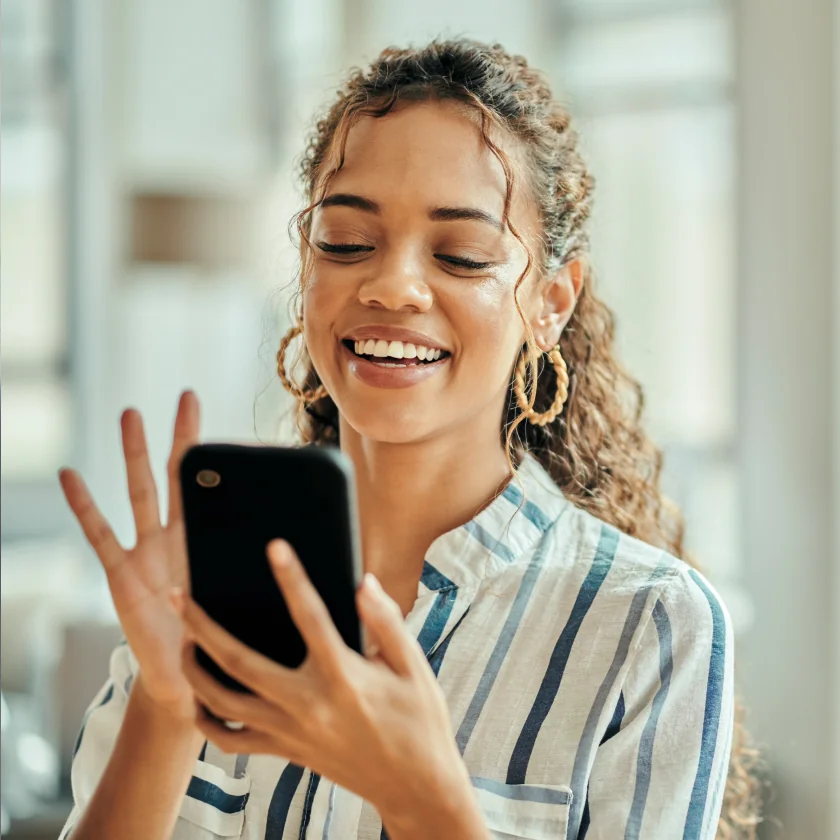 Women smiling while holding phone